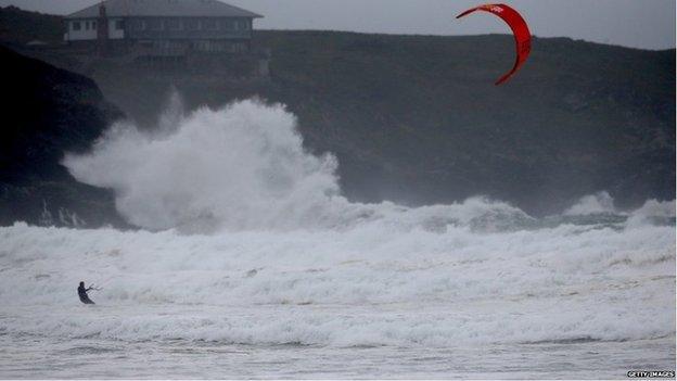 A kite surfer braved the waves crashing into Newquay, Cornwall.