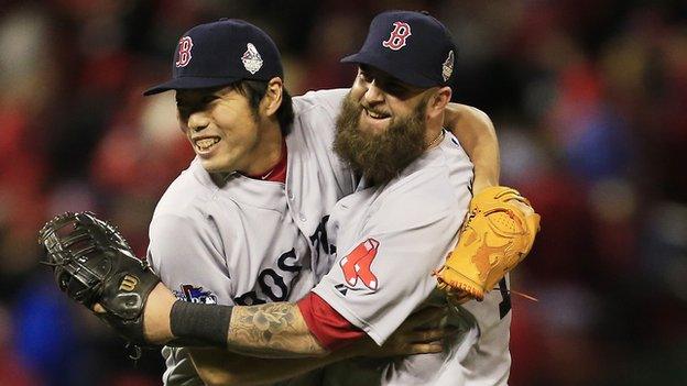 Koji Uehara of the Boston Red Sox celebrates with teammate Mike Napoli after victory over St Louis Cardinals in game four of the 2013 World Series at Busch Stadium