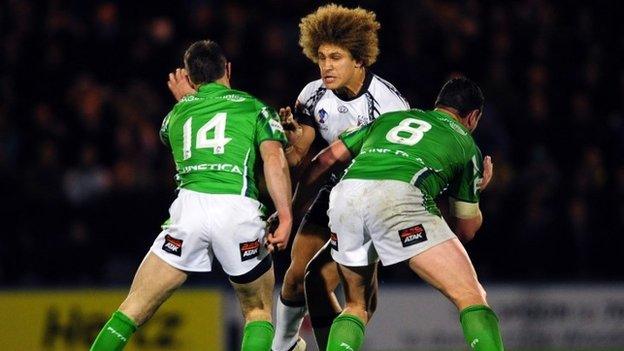 Fiji's Eloni Vunakece is tackled by Ireland's Bob Beswick and Brett White