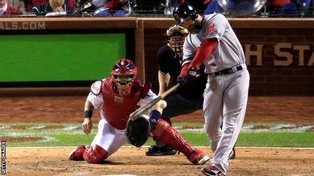 David Ross of the Boston Red Sox hits a ground rule double in the seventh inning as Yadier Molina of the St Louis Cardinals looks on