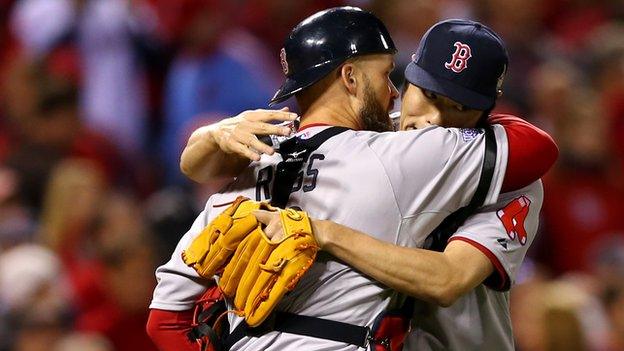 Koji Uehara (right) celebrates with David Ross of the Boston Red Sox after they defeated the St Louis Cardinals 3-1