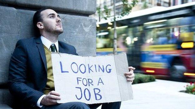 Man with a sign saying he is looking for a job