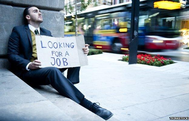 Man with a sign saying he is looking for a job