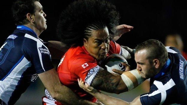 Tonga's Fuifui Moimoi is tackled playing against Scotland