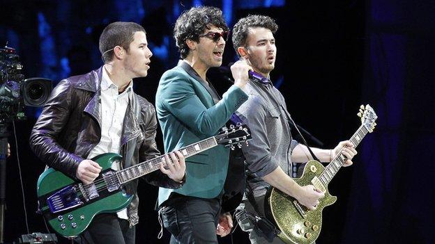 Jonas Brothers perform on stage