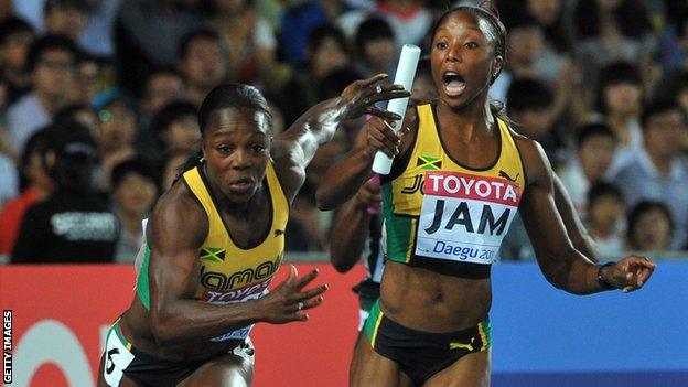 Jamaicas Veronica Campbell-Brown (L) takes the baton from Sherone Simpson during the women's 4x100 metres relay final at the 2011 World Championships