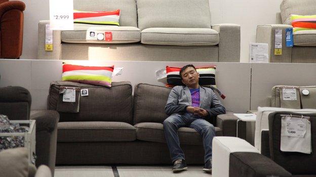 Man sleeps on a chair in Ikea