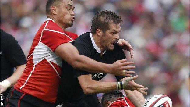 New Zealand captain Richie McCaw is tackled by Japan counterpart Toshiaki Hirose