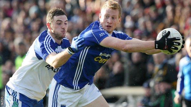 Ballinderry's Daniel McKinless challenges Kieran Hughes of Scotstown