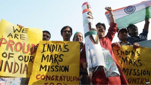 Indians celebrate the launch of the Mars Orbiter Mission in Calcutta on November 5, 2013.