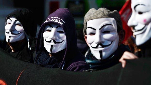 protesters in Guy Fawkes masks