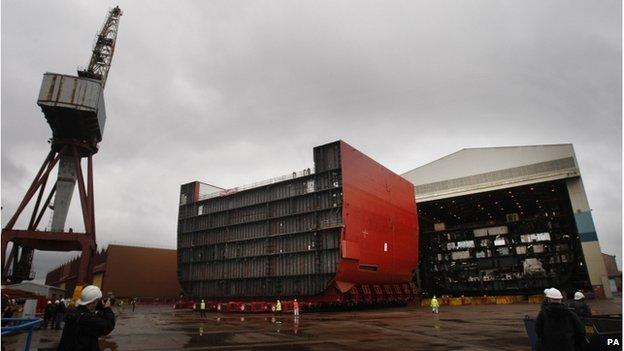 File photo dated 09/04/12 of a section of the hull of HMS Queen Elizabeth (left) being moved at BAE Systems" Govan Shipyard in Glasgow