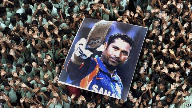 File picture of Indian students holding a large poster of Indian cricketer Sachin Tendulkar