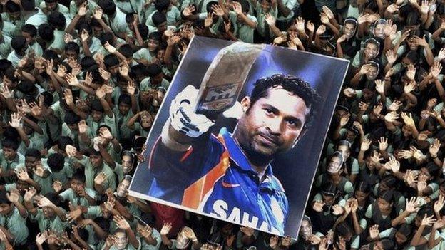 File picture of Indian students holding a large poster of Indian cricketer Sachin Tendulkar