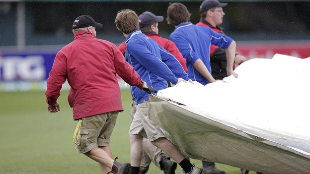 Hobart groundstaff cover the pitch