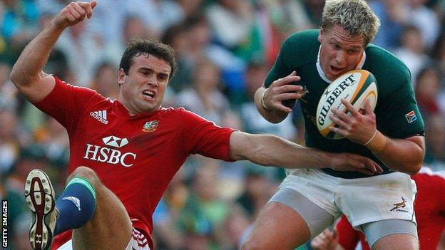 Jean de Villiers catches the ball under pressure from Jamie Roberts during the first test between South Africa and the Lions in 2009