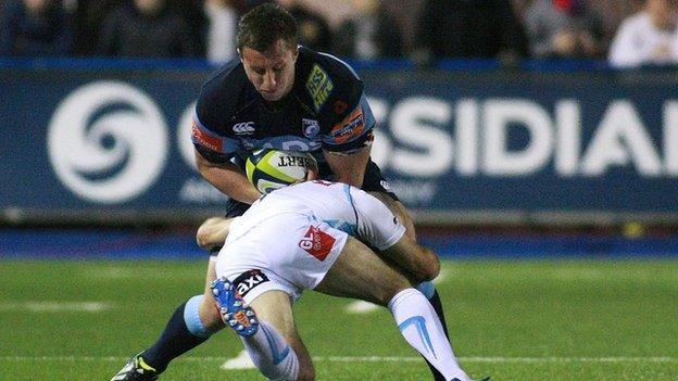 Cardiff Blues' Tom Davies is tackled by Worcester's Paul Hodgson