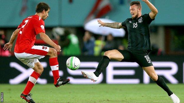 Austria's Gyorgy Garics competes for the ball with Anthony Pilkington