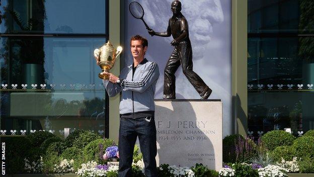 Andy Murray poses with the Wimbledon Men's Singles Trophy next to the Fred Perry statue