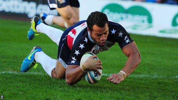 USA captain Joseph Paulo scores a try