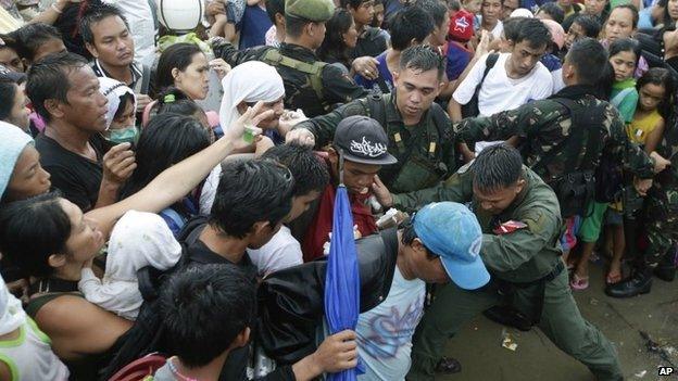 Typhoon survivors at the airport in the Philippine city of Tacloban, 12 November 2013