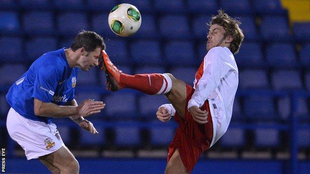 David Rainey of Glenavon goes in bravely against Steven McCullough of Ards