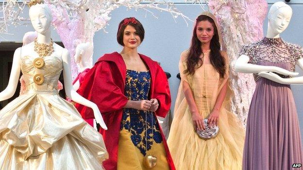 Models pose in Disney inspired dresses