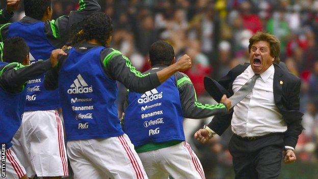 Mexico coach Miguel Herrera celebrates with his players after a goal against New Zealand