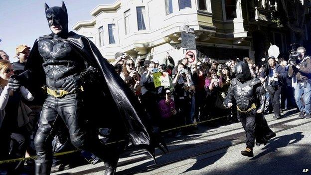 Miles Scott (right), walks with a man dressed as Batman in San Francisco, California on 15 November 2013