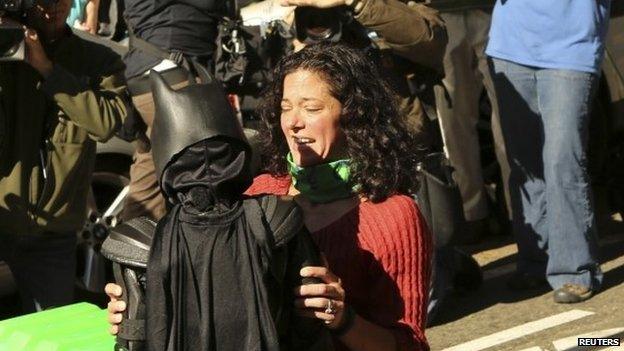 Batkid is hugged after rescuing a woman in distress in San Francisco on 15 November 2013