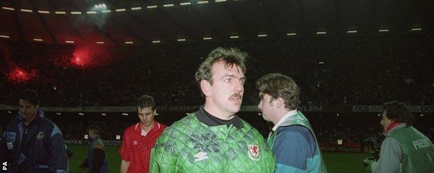 Neville Southall is dejected after his side's defeat by Romania