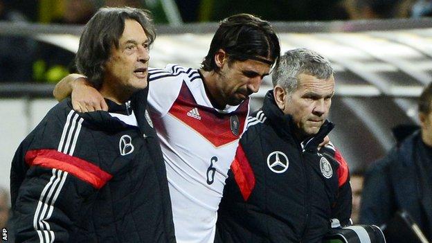 Germany and Real Madrid midfielder Sami Khedira is helped off the pitch after tearing a cruciate ligament while playing for his country against Italy