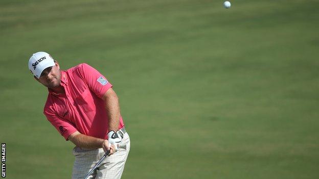 Graeme McDowell plays a chip in Dubai