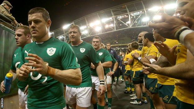 Brian O'Driscoll troops off with dejected Ireland team-mates after the 32-15 defeat by Australia