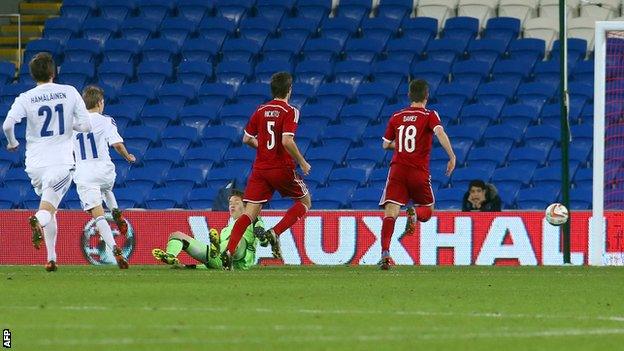 Riku Riski (2nd L) scores for Finland