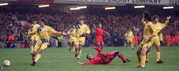 Gary Speed is sent tumbling in the Romania box