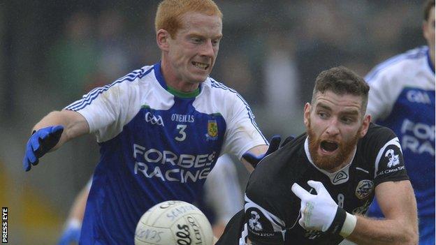 Paul Greenan of Ballinderry in action against Kilcoo's Conor Nevin