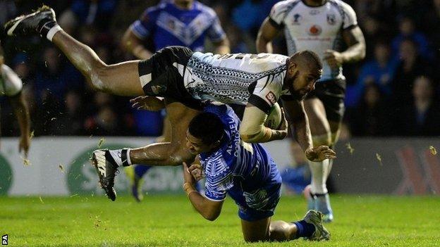 Fiji's Marika Koroibe is tackled by Samoa's Anthony Milford