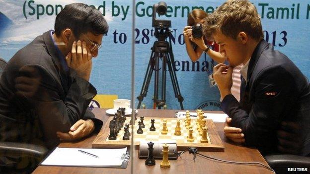 Norway"s Magnus Carlsen (R) plays against India"s Vishwanathan Anand during the FIDE World Chess Championship in the southern Indian city of Chennai November 15, 2013