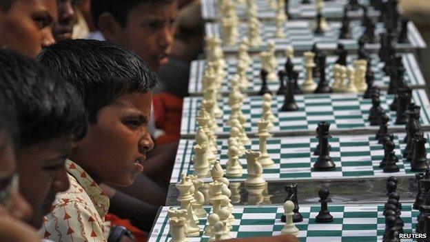 School children play chess in a public park in Chennai