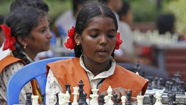 A schoolgirl plays chess in a public park in Chennai