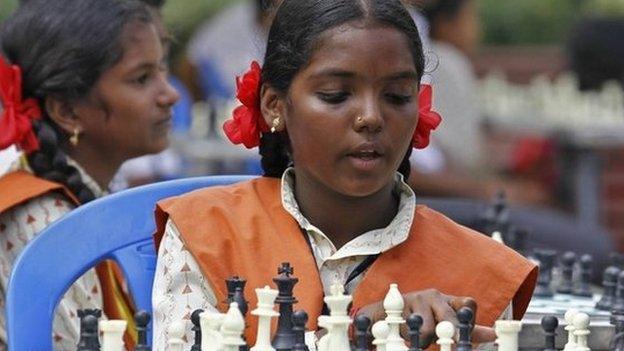 A schoolgirl plays chess in a public park in Chennai