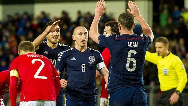 Scotland goalscorer Scott Brown is congratulated by Charlie Adam