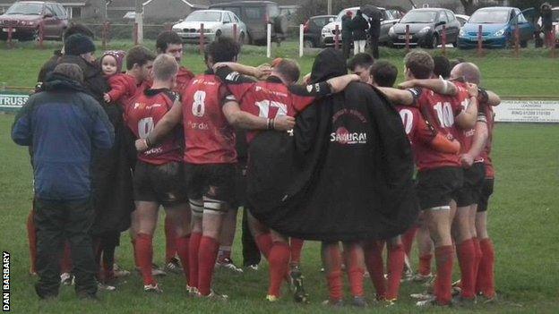 Redruth team in a post-match huddle.