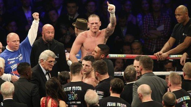 George Groves is held aloft at the end of the fight against Carl Froch