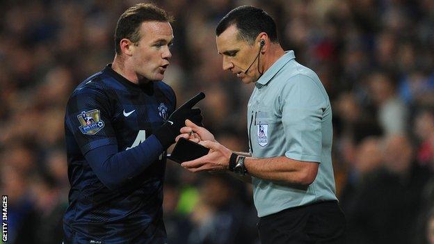 Wayne Rooney talking with referee Neil Swarbrick