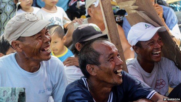 Men from Estancia town on Panay Island, central Philippines rejoice over the win of Pacquiao against Rios last Sunday. Photo: JP Sarsoza