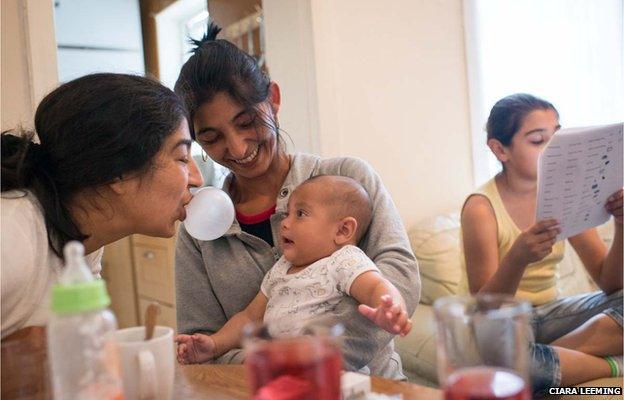 Zaneta (centre) and her younger sister Martina (left) entertain baby Roman – Zaneta's grandson