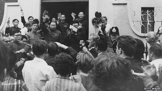 British supporters of the communist People's Republic of China listen as a Chinese diplomat exclaims Long live Chairman Mao, outside the Chinese Secretariat in Portland Place, London