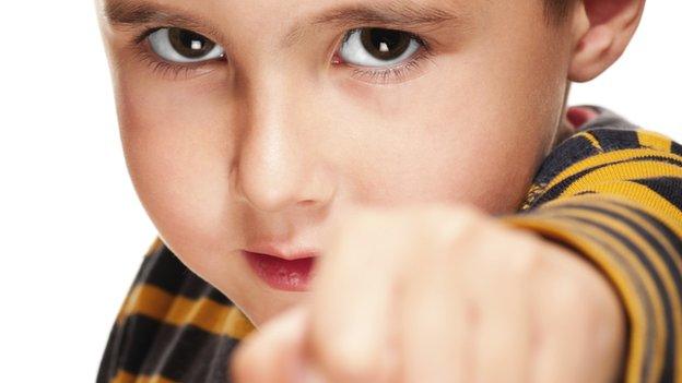 A child holding up his fist